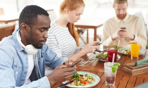 young-people-using-mobile-phones-communicating-online-sitting-table-eating-cafe-people-using-mobile-phones-157212670
